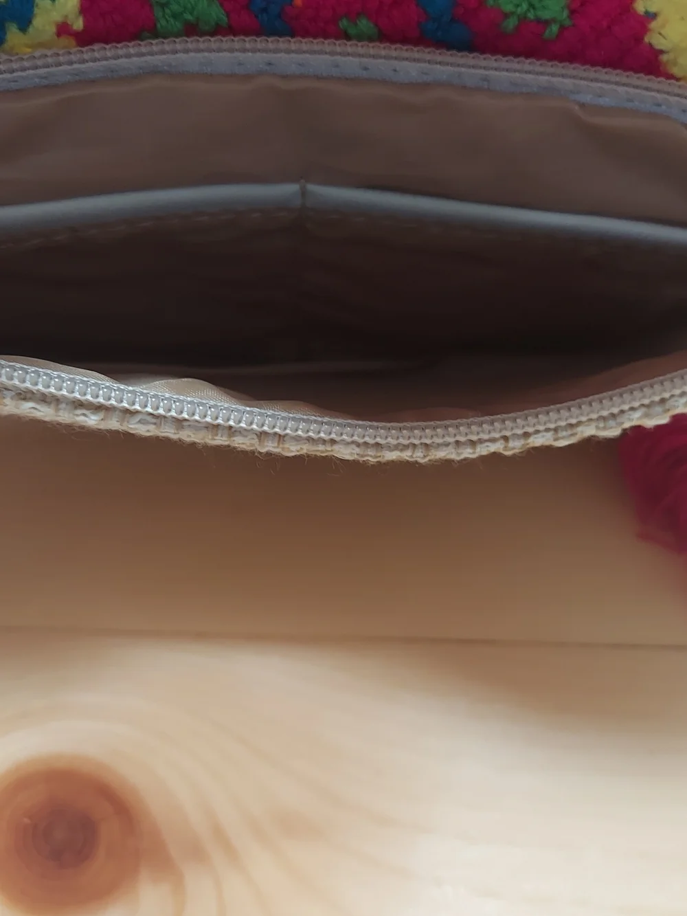 Handmade Wayuu-style jute clutch featuring a vibrant, multicolored beaded floral